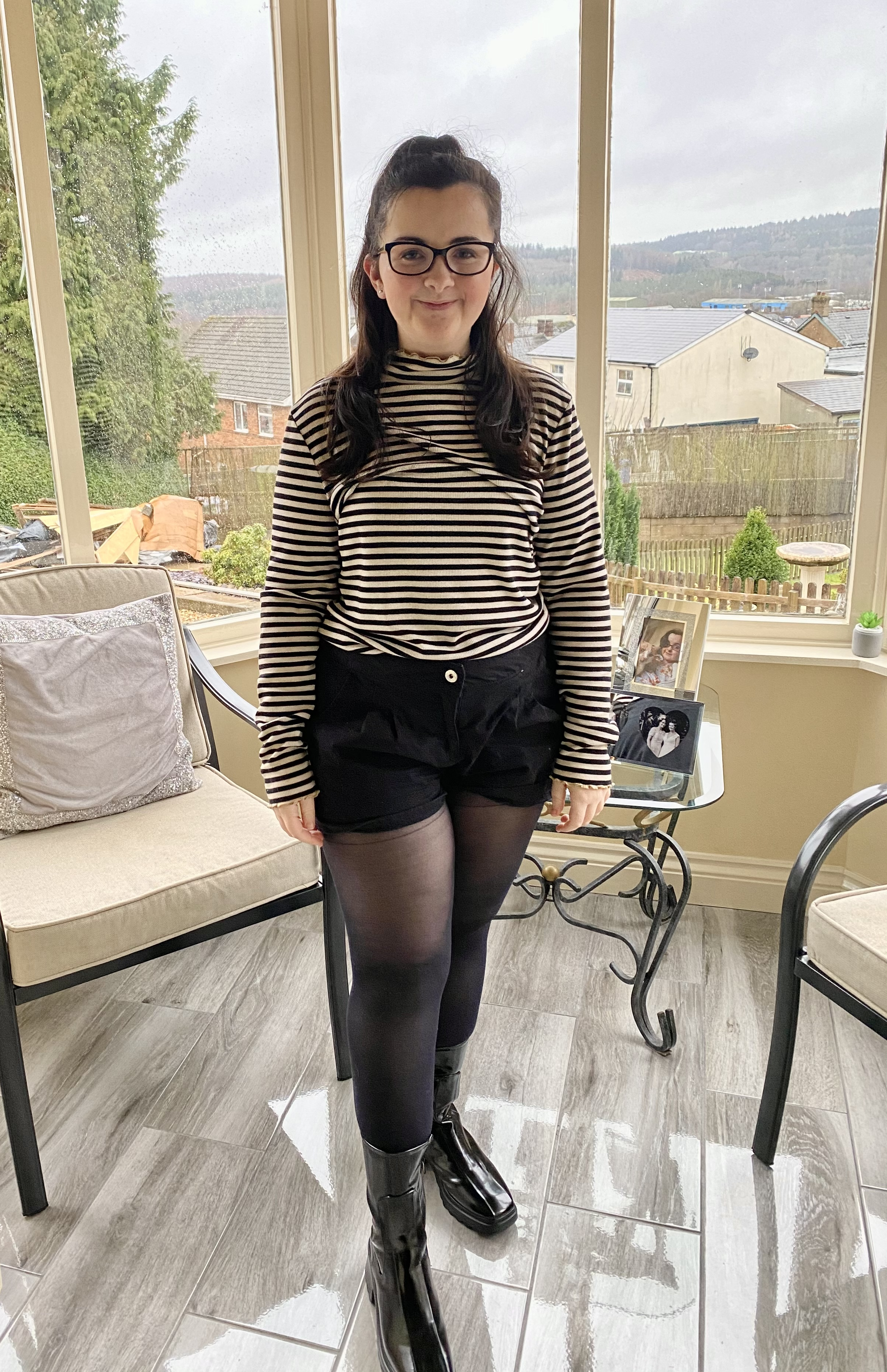 Tasmin, a young women with MCAS stood in a conservatory